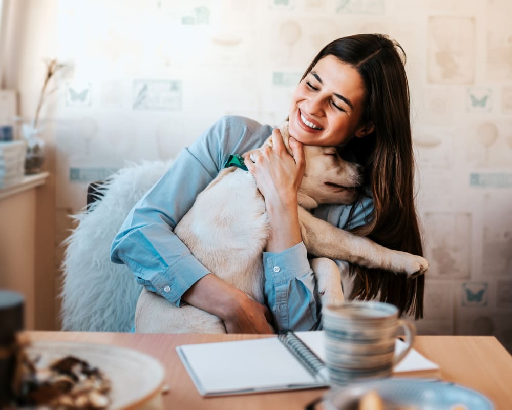 Woman holding dog. Veterinary CT Services in Englewood